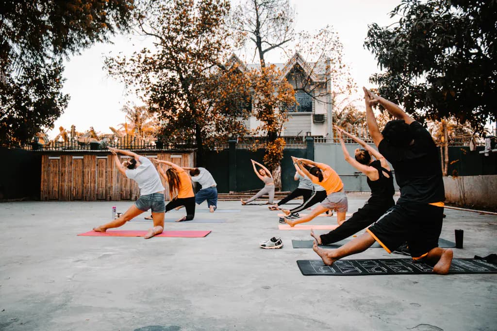 A group practising yoga outdoors