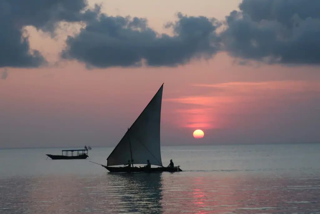 A dhow sailing at sunset